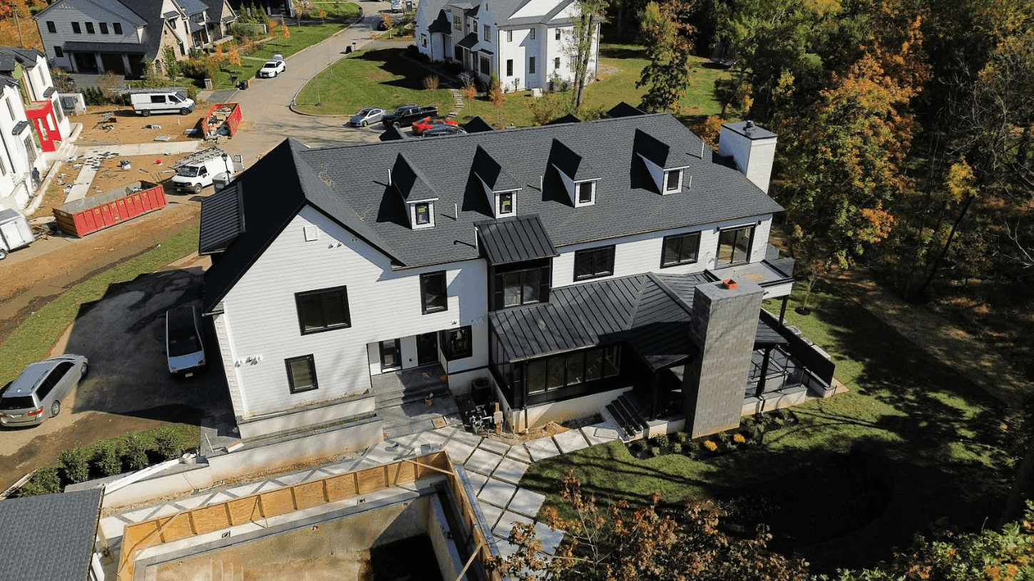 Aerial view of a finished new construction home with landscaping