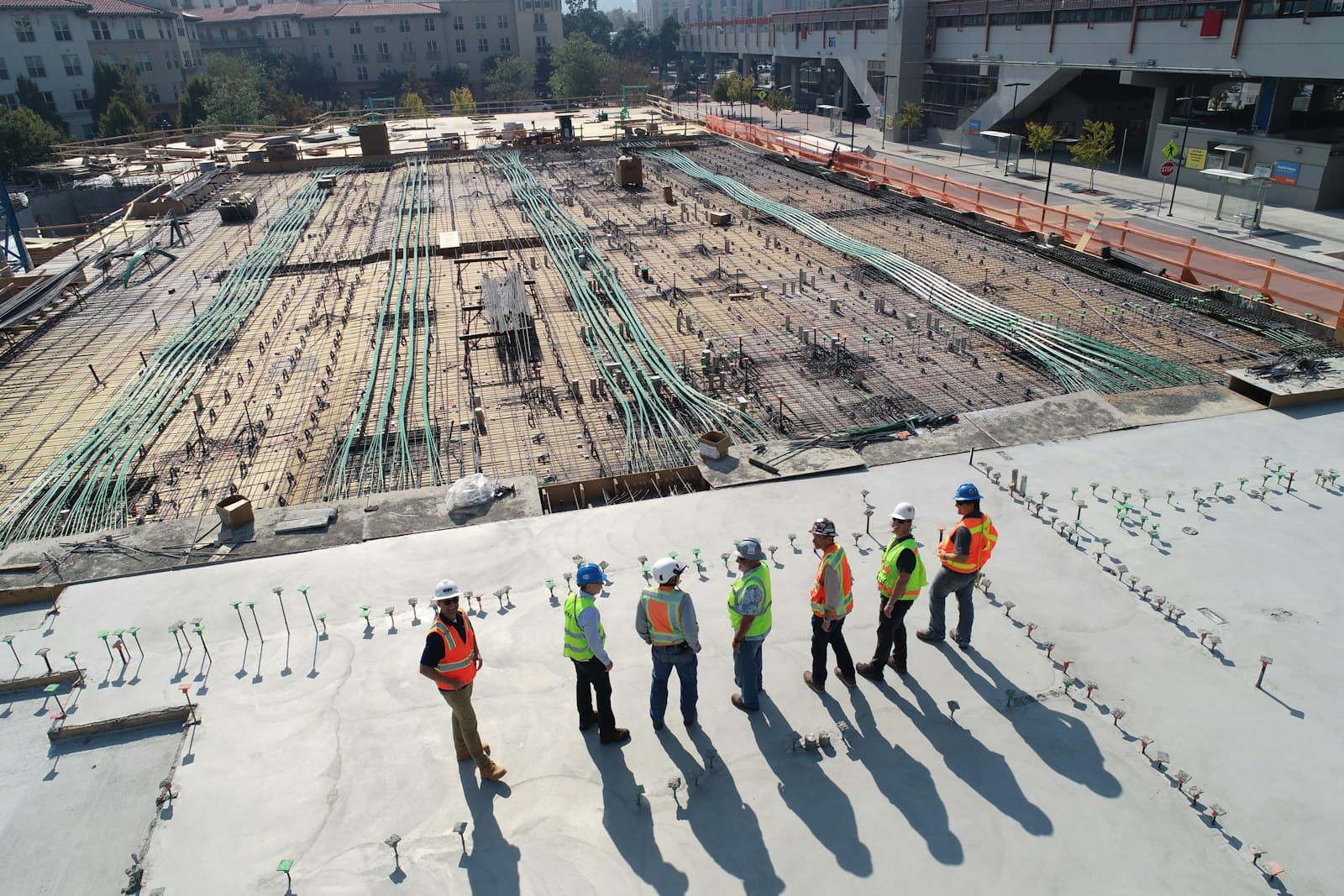 Aerial view of a large-scale commercial construction site with foundation work underway